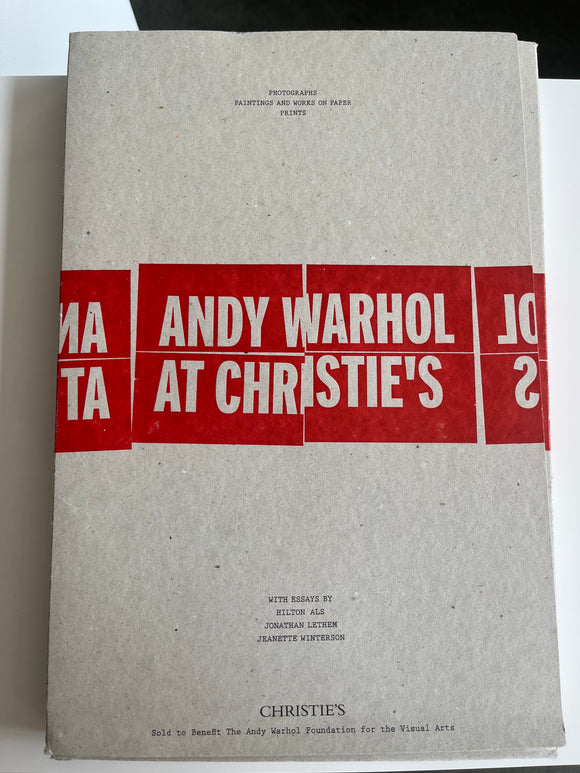 Book titled 'Andy Warhol at Christie's' with red and white text on a gray cover.